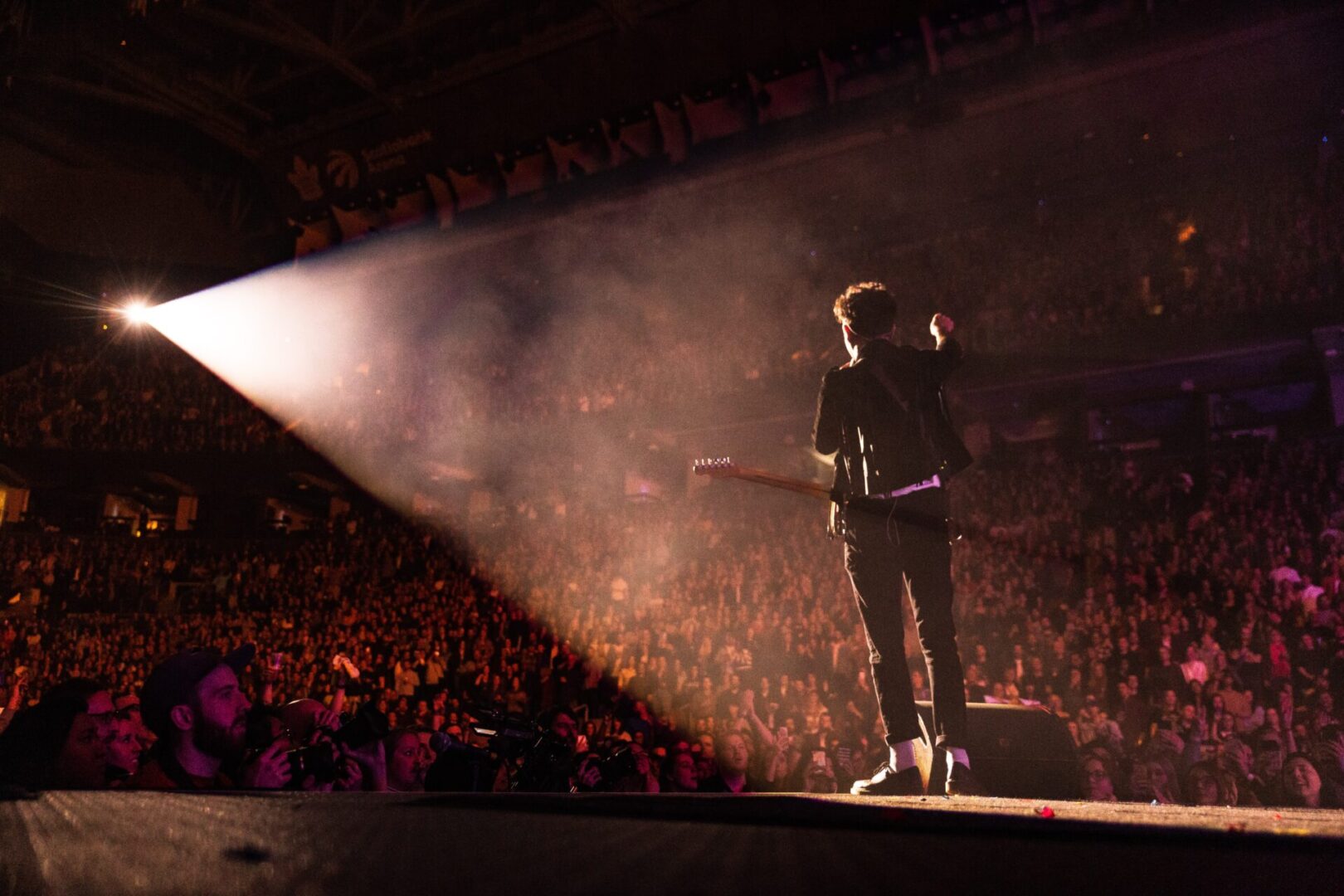 A man standing on stage with a microphone.