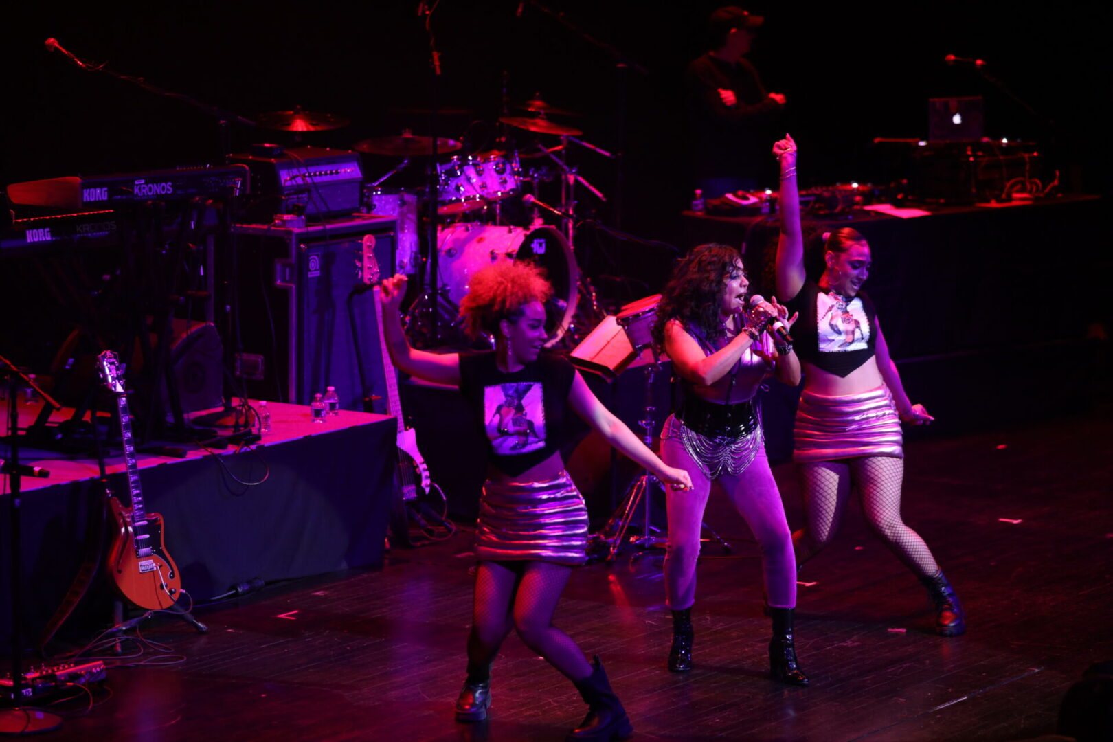 A group of women performing on stage in front of a crowd.