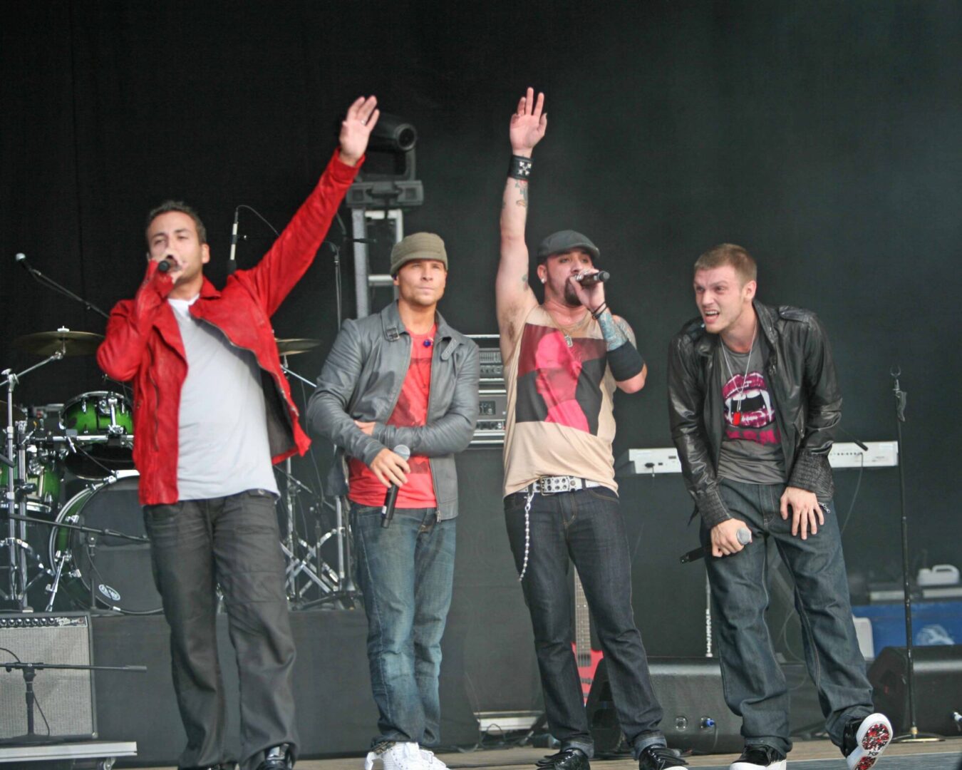 A group of young men standing on top of a stage.