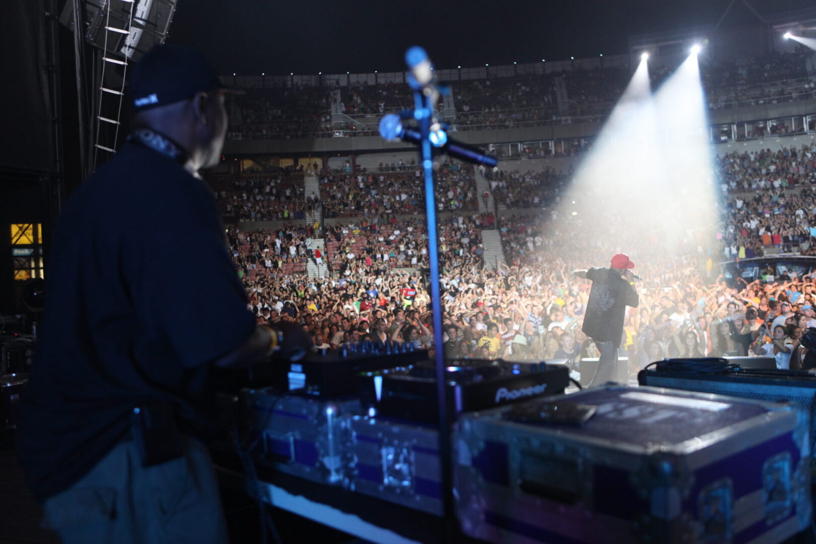 A person standing next to a microphone on top of a stage.