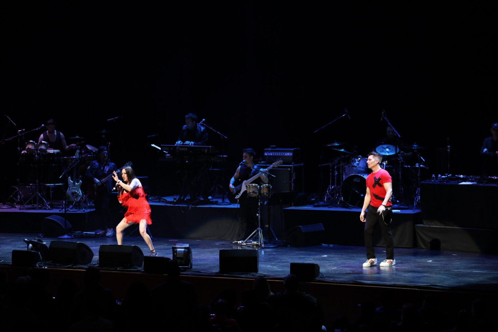 A couple of people on stage with musical instruments.