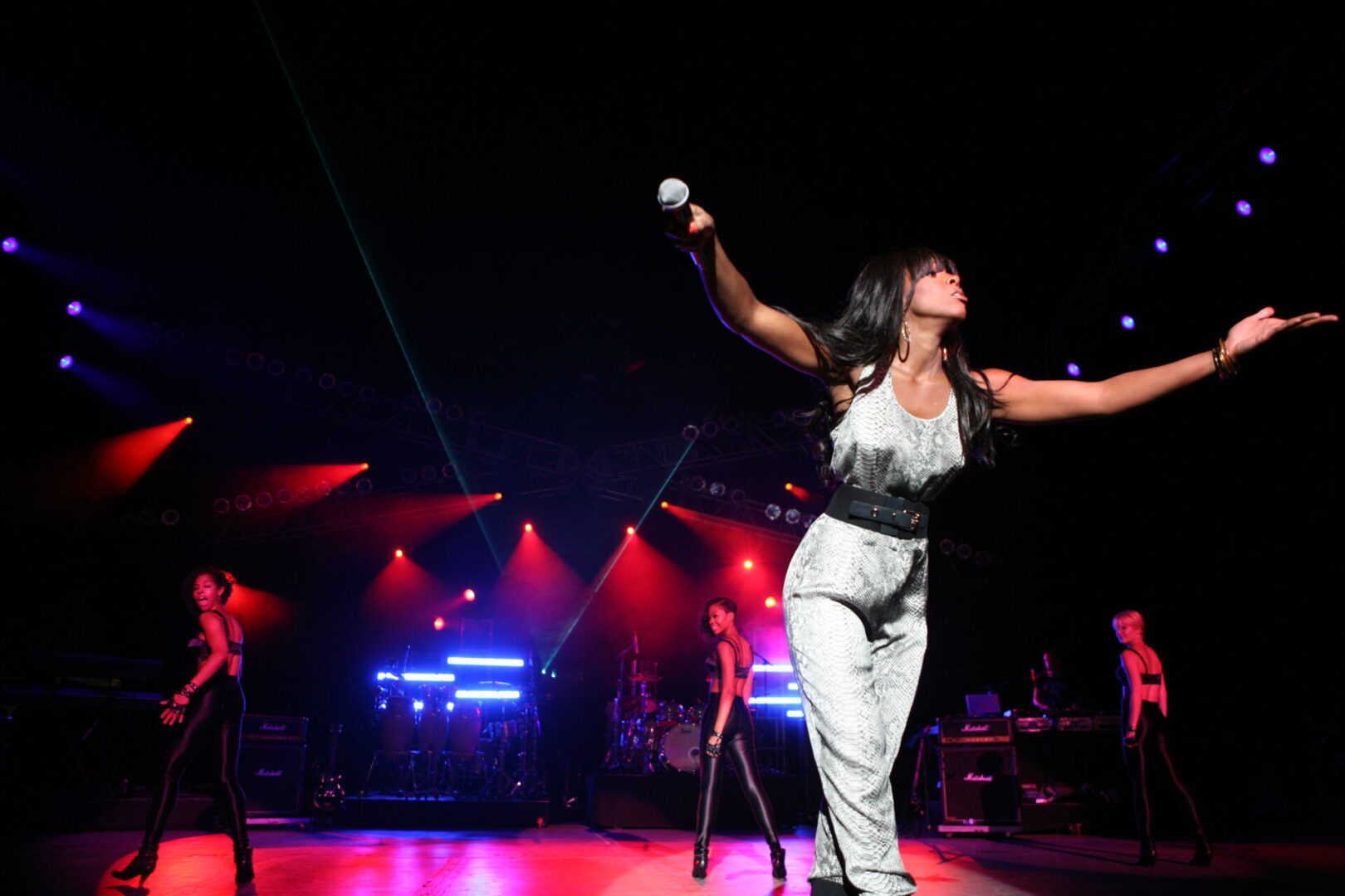 A woman is playing wii on stage