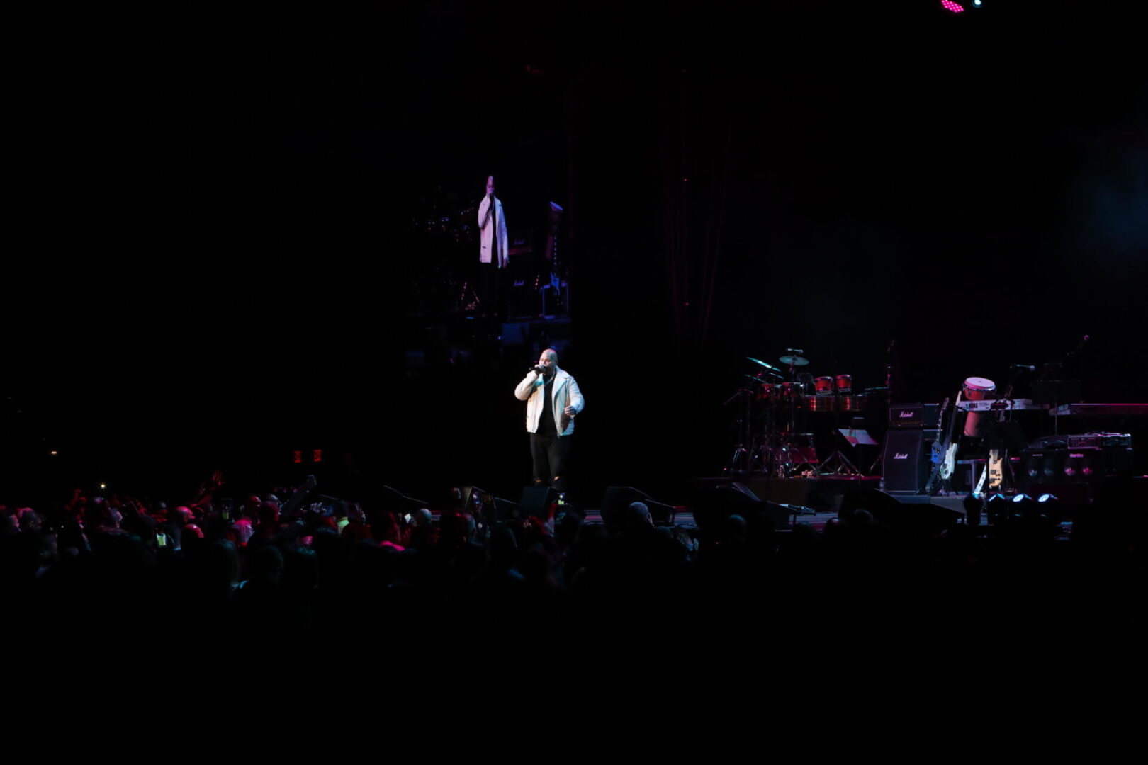 A man standing on stage in front of an audience.