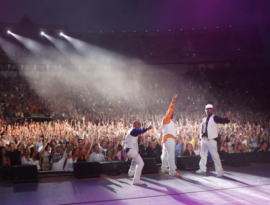 A group of men standing on top of a stage.